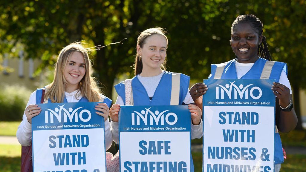 3 student nurses holding signs at safe staffing protest 2025